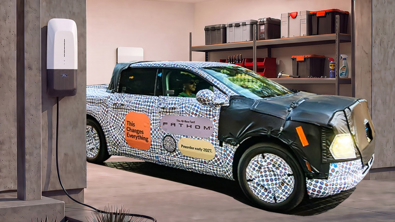A camouflaged Ford Fathom prototype parked in a garage equipped with Ford's next-gen home charger