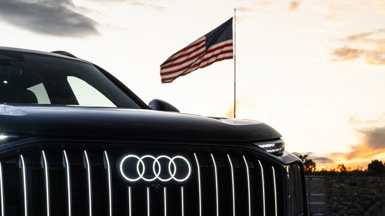 Audi SUV front end pictured in front of a US flag