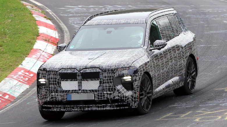 Spy shots of a BMW X7 M60 SUV prototype at the Nürburgring