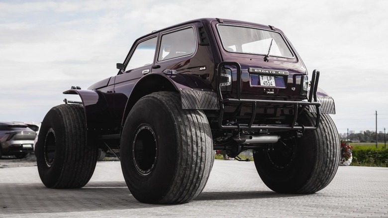 A rear three-quarters view of the Lada Niva Marsh revealing its wide fender extensions.