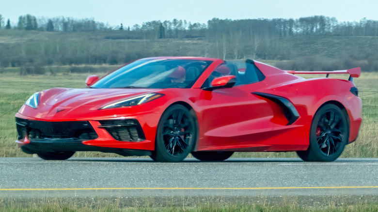 A red Chevrolet Corvette being driven on the road