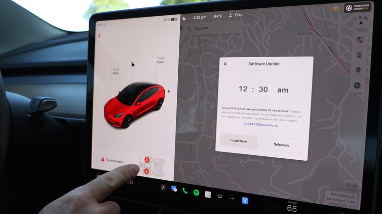 A Tesla Model 3 infotainment screen with software update information displayed