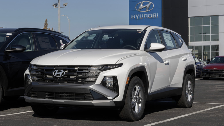 A white Hyundai Tucson in a dealership lot