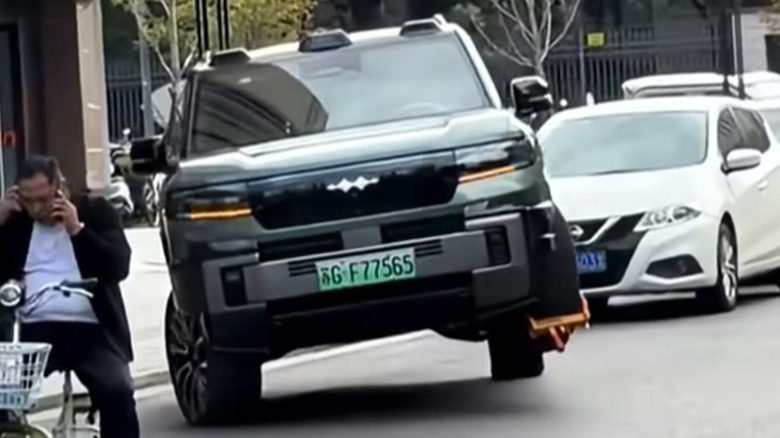 A Fangchengbao Bao 8 driving on three wheels