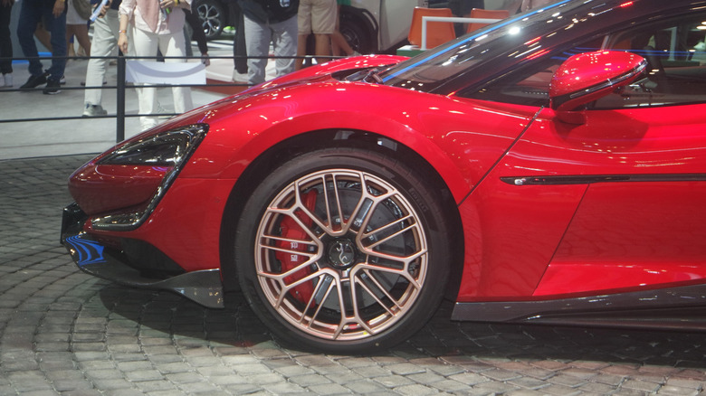 Front side shot of a red Yangwang U9 displaying its gold wheels