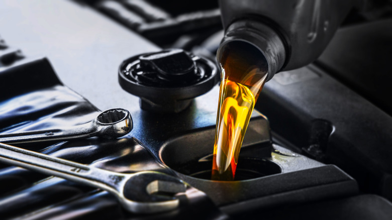 Motor oil being poured into a car engine