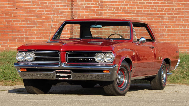 Front three-quarter image of a 1964 Pontiac GTO in red from Mecum auctions