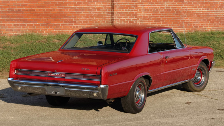 Rear three-quarter image of a 1964 Pontiac GTO in red from Mecum auctions