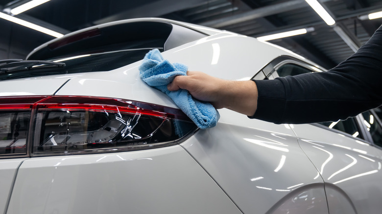 A microfiber towel being used to clean a car
