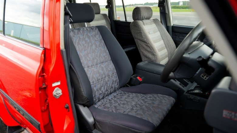 The interior of the Land Cruiser Fire Command vehicle with gray cloth and a mismatching driver's seat