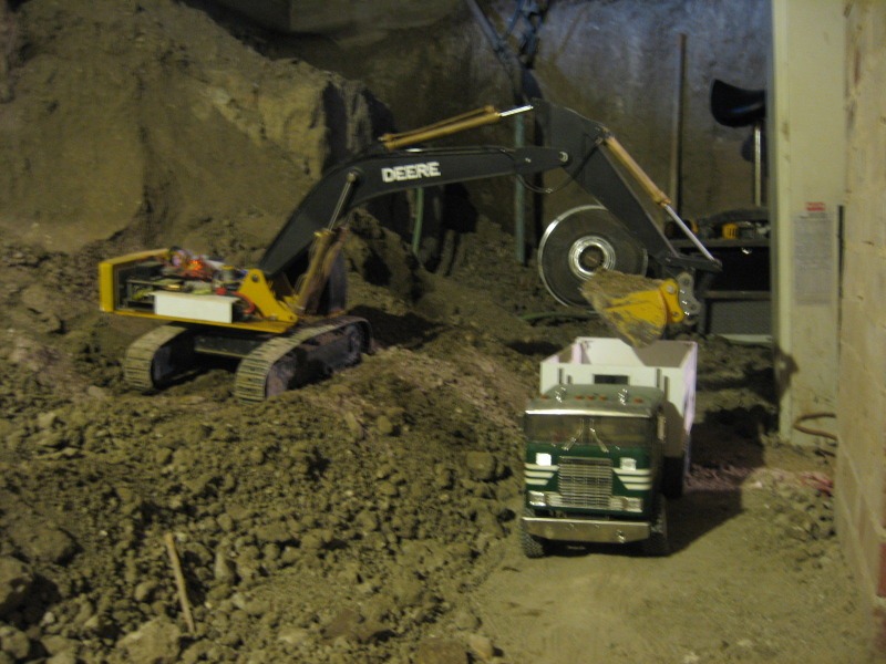 Canadian Digs Out Basement Using Only Radio Controlled Scale Tractors And Trucks