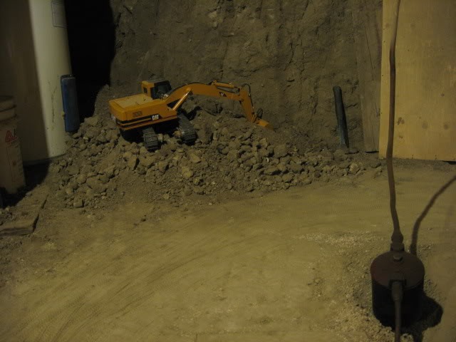 Canadian Digs Out Basement Using Only Radio Controlled Scale Tractors And Trucks