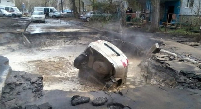  Burst Pipe Sends Lada into Big Hole in the Road