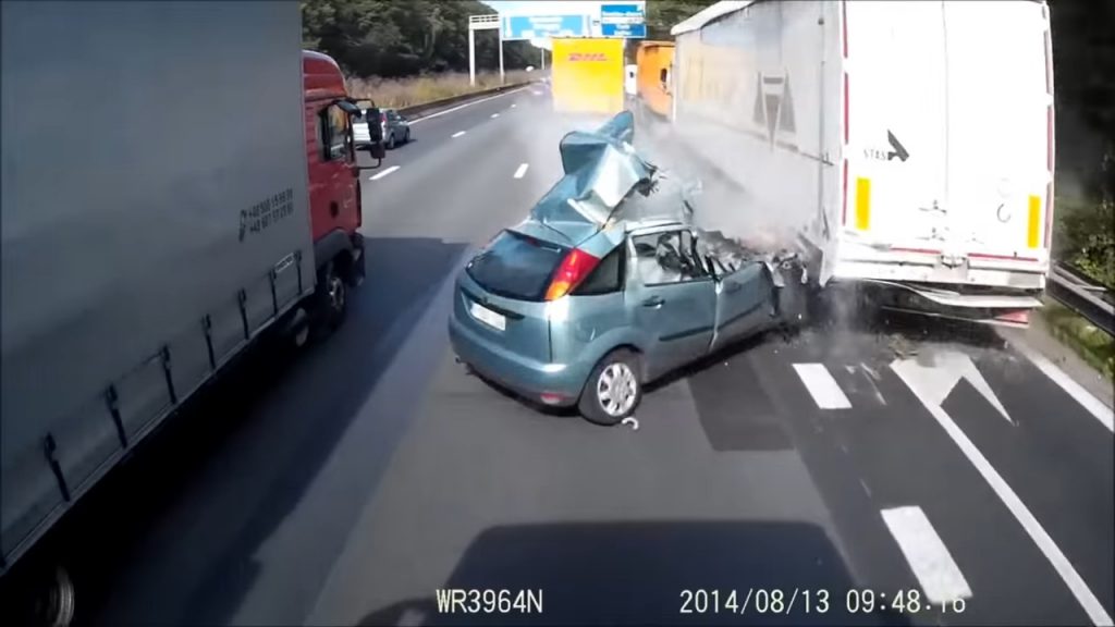  Woman Crashes Into Truck, Gets Hit By 2nd Truck, Yet Makes it Out Alive