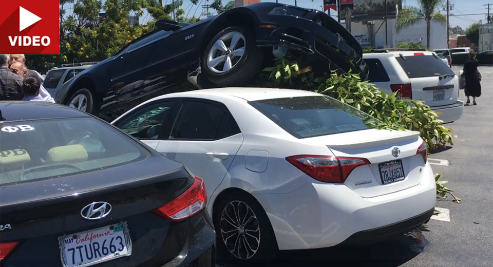 Ford Mustang Crashes In Parking Lot And Lands On Top Of A Corolla