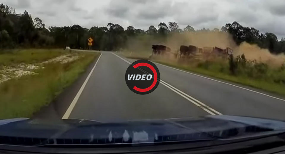 Semi Truck Carrying Logs Rolls Over On Its Side In Australia