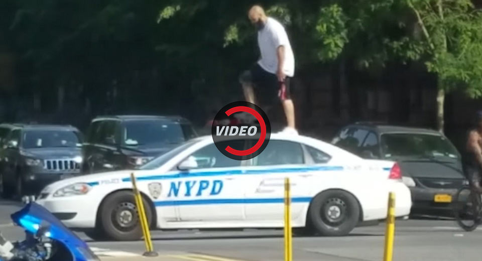Man Climbs On Top Of NYPD Cruisers In Harlem