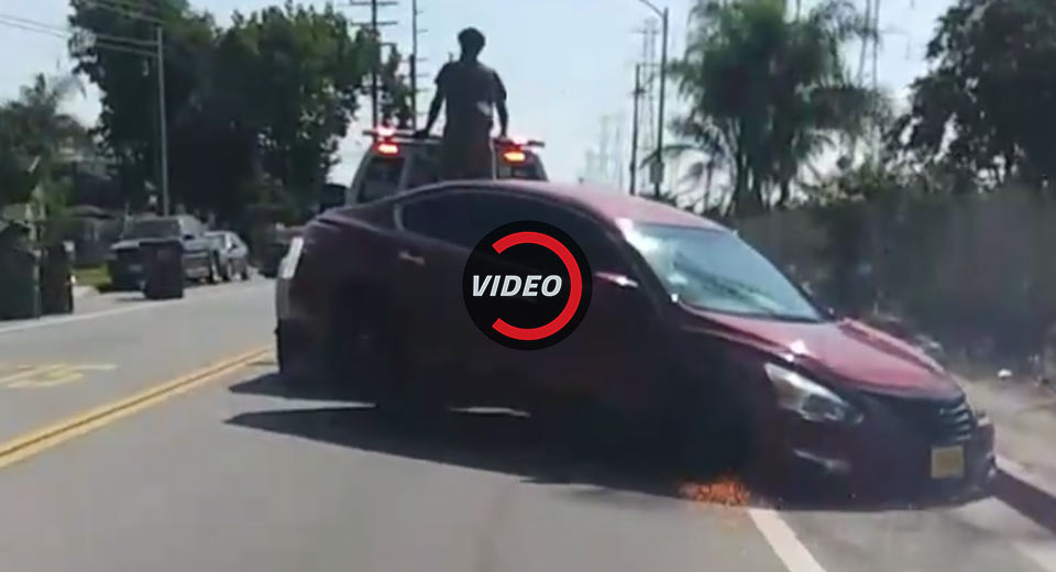 Car Owner Furiously Tries To Unhitch Vehicle From Repo Man’s Moving Tow Truck