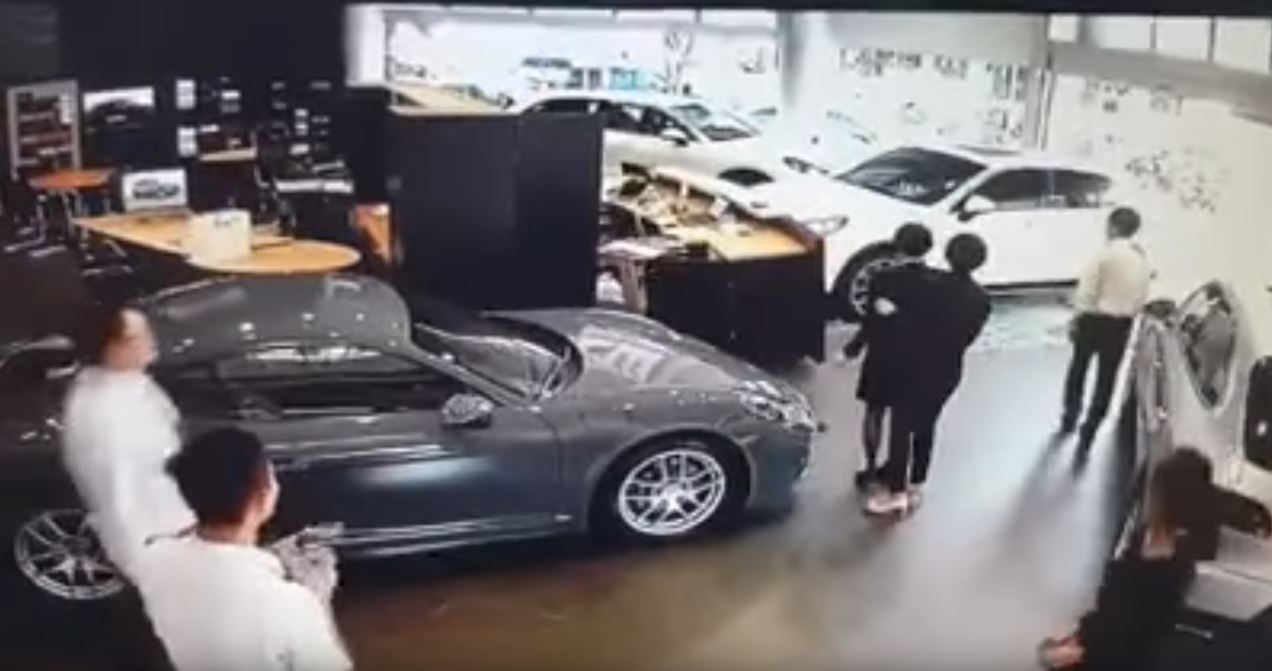 porsche-cayenne-man-smashes-into-dealer-5 Disgruntled Owner Smashes Cayenne Through Porsche Dealership After Not Getting Optional Extras