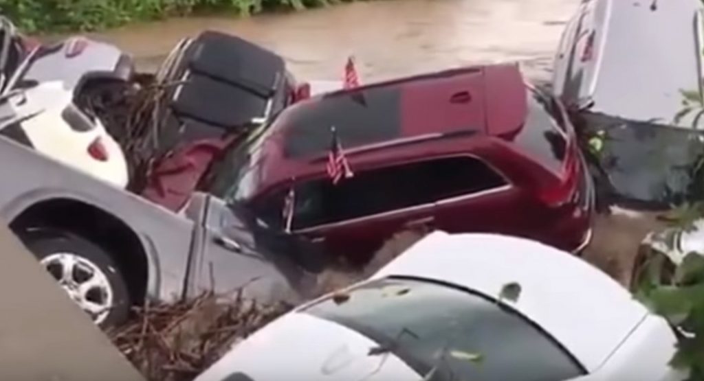 Flood Pushes Cars Off Dealership Lot And Straight Into A Bridge
