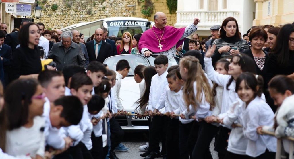  50 Kids Pull Priest In A Porsche Through The Streets Of Malta
