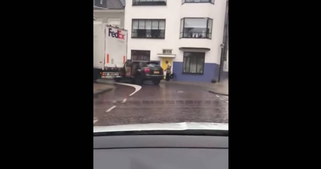 Parked Porsche Cayenne Gets Dragged Along By FedEx Truck