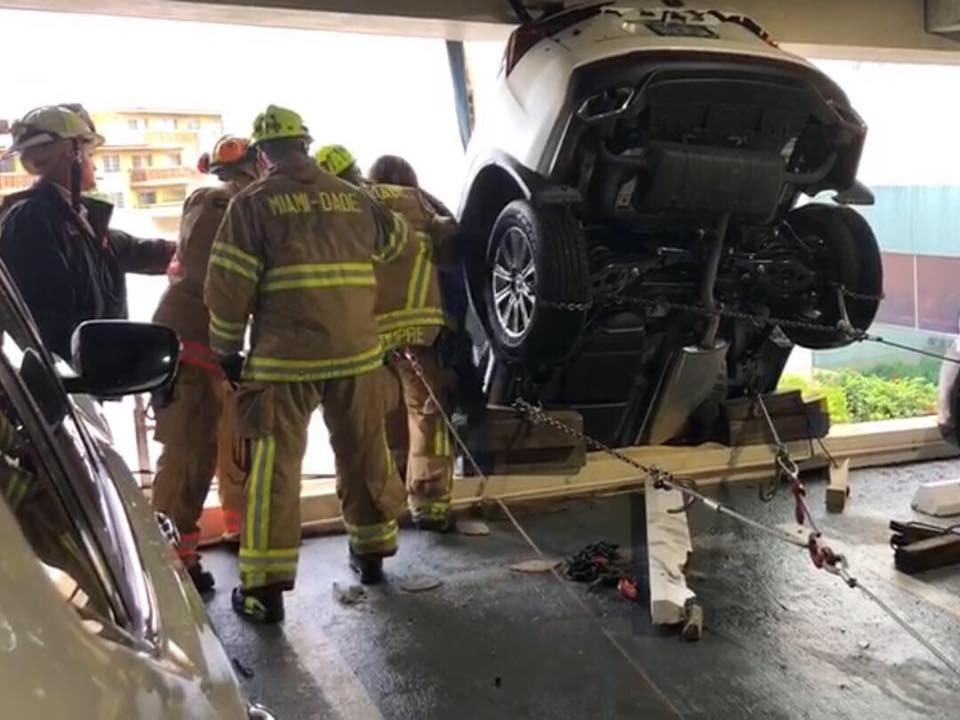 Lexus Dangles Over Parking Garage-5 Woman Crashes Lexus Through Cables And Gets Stuck Dangling Over Parking Garage