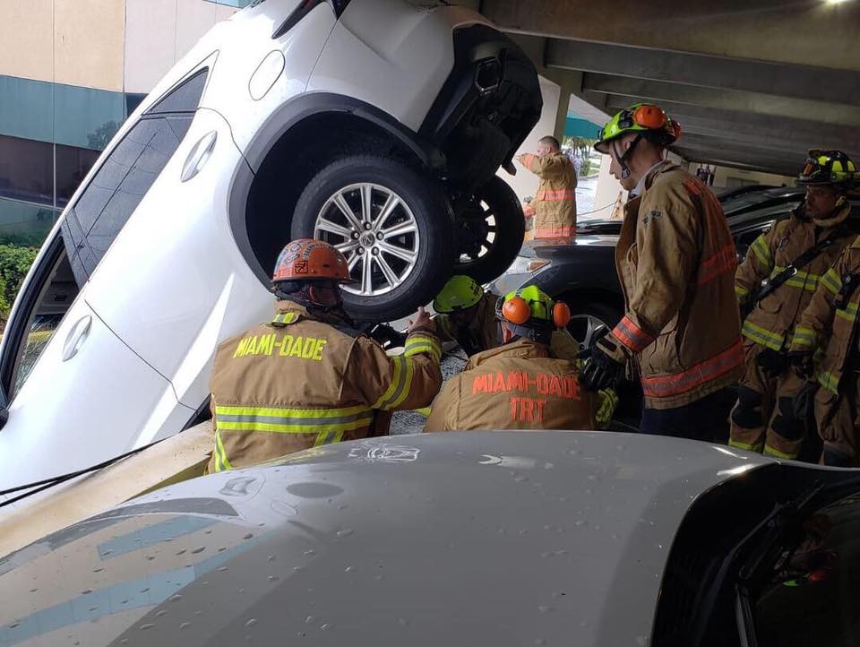 Lexus Dangles Over Parking Garage-2 Woman Crashes Lexus Through Cables And Gets Stuck Dangling Over Parking Garage