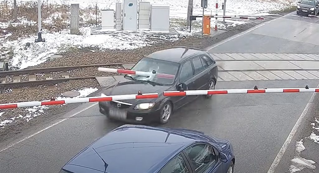  Driver Evading Police Nearly Impales Himself While Smashing Through Train Crossing Barrier