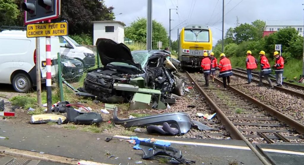 VW Driver Gets Stuck Between Railroad Crossing Gates And Makes A Run For It Before Train Smashes SUV