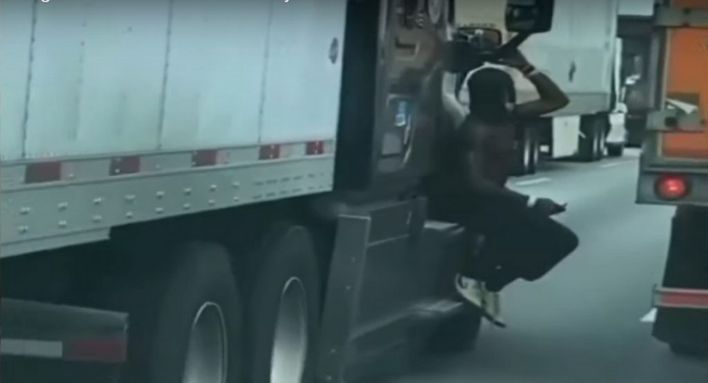 Man Filmed Hanging On To The Side Of Semi On The Freeway