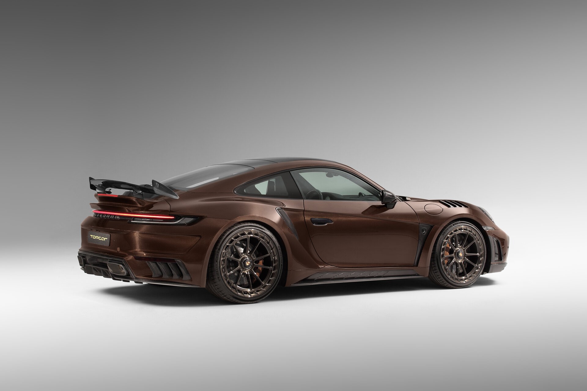 TopCar Dresses Their Tuned Porsche 911 Turbo S In Brown Carbon Fiber