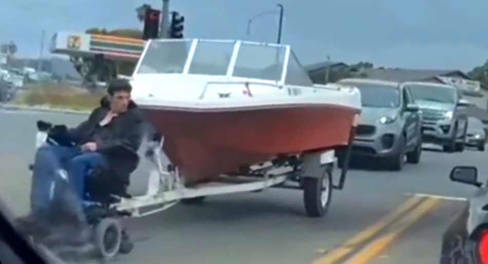  Man In Motorized Wheelchair Tows Powerboat Down California Road