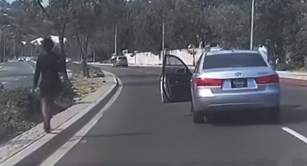 Bizarre Stunt Sees Woman Exit Her Car In The Middle Of The Road, Lets It Roll Into Oncoming Traffic