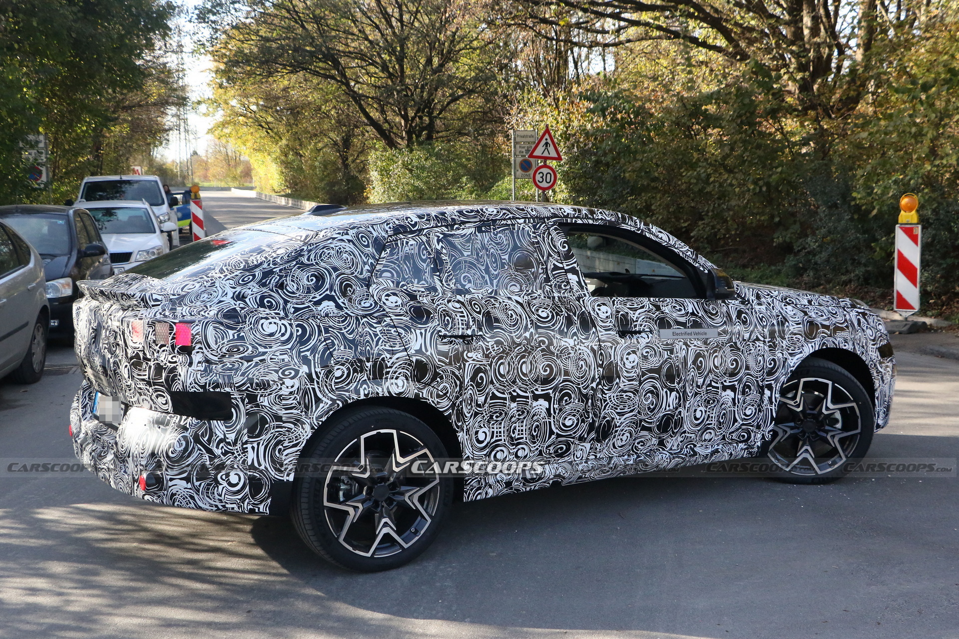 2024 BMW iX2 EV Spied With A Covered Grille And Sloping Roofline