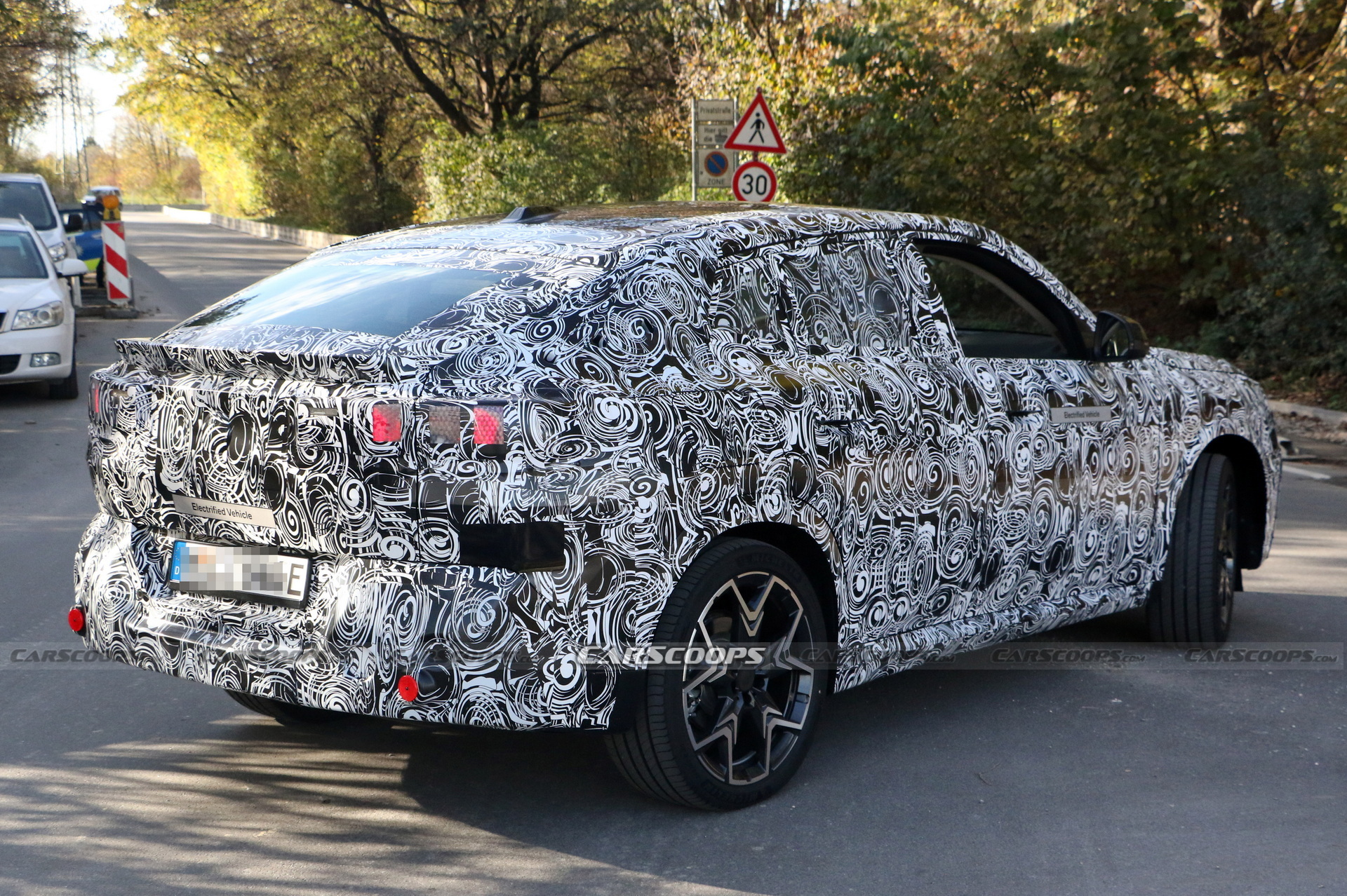 2024 BMW iX2 EV Spied With A Covered Grille And Sloping Roofline