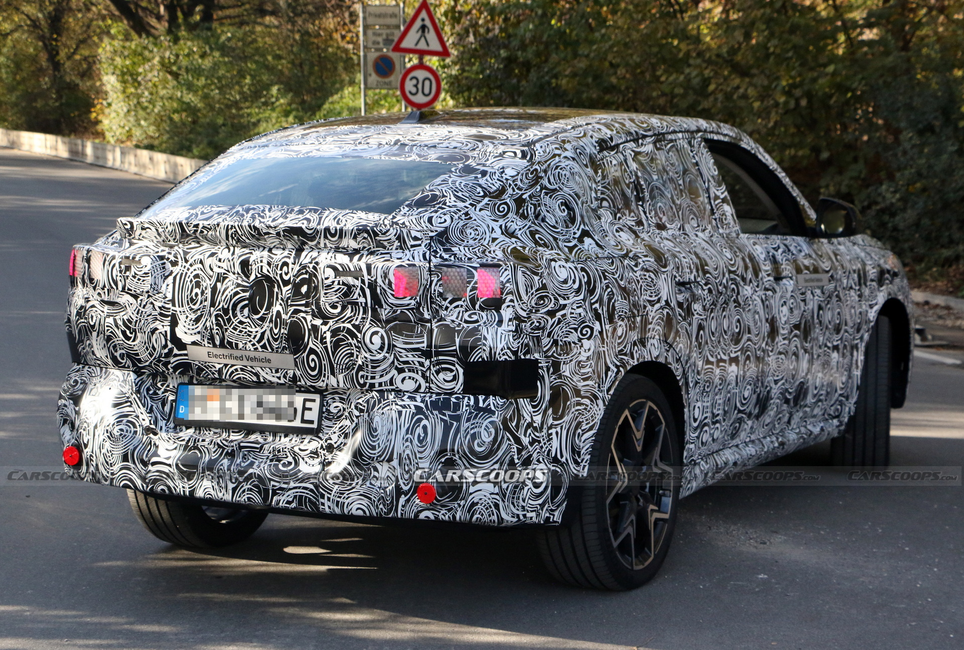 2024 BMW iX2 EV Spied With A Covered Grille And Sloping Roofline