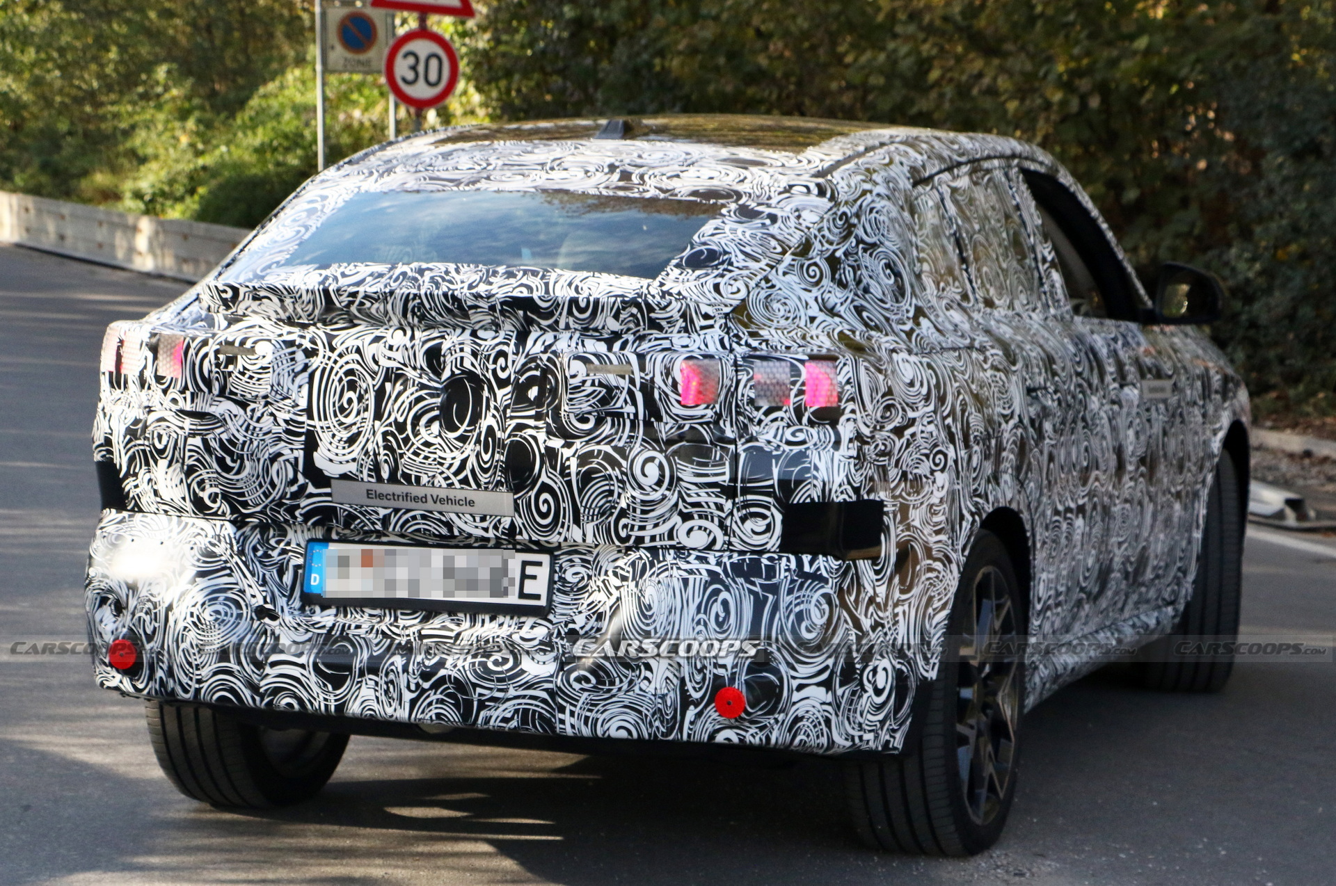 2024 BMW iX2 EV Spied With A Covered Grille And Sloping Roofline