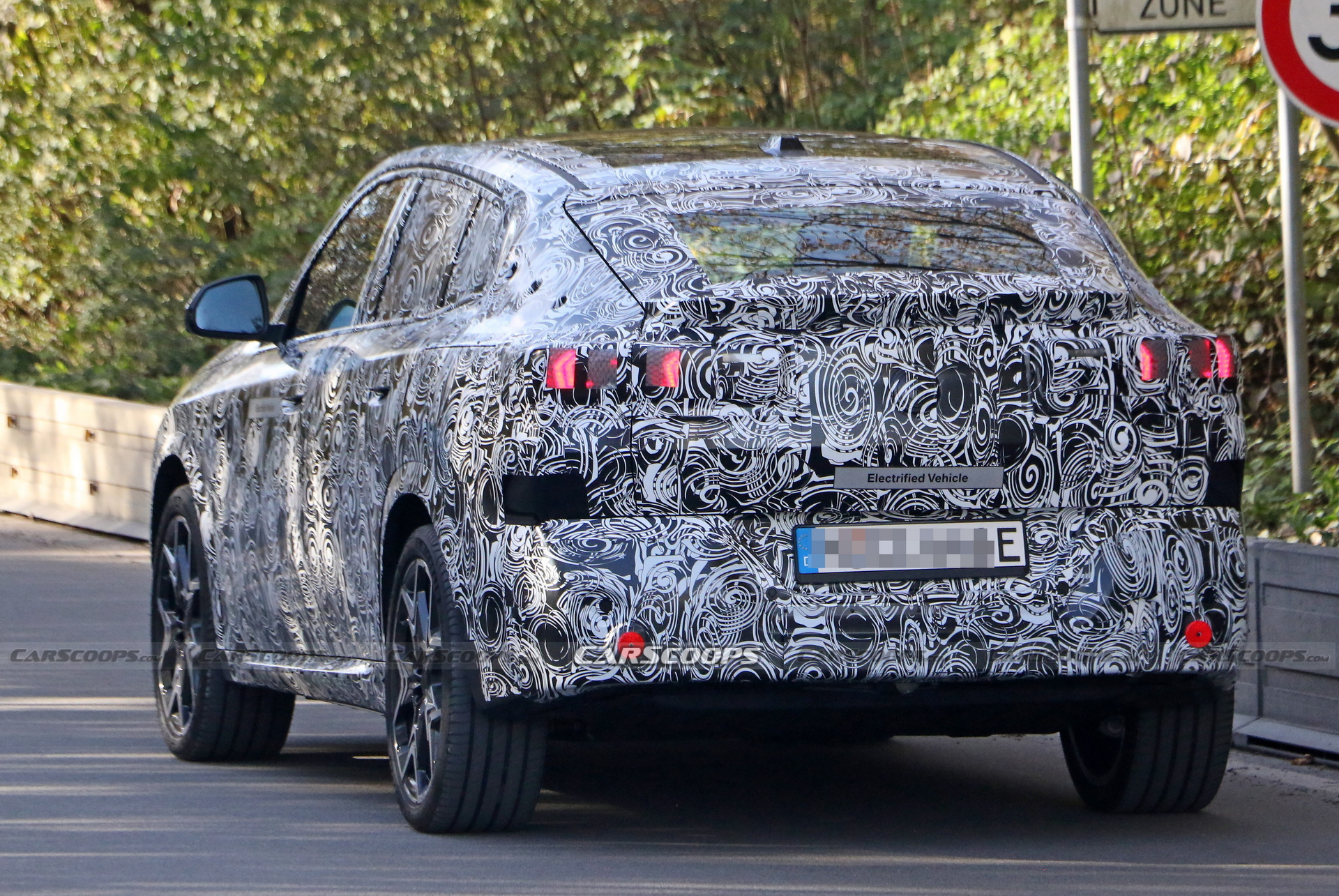 2024 BMW iX2 EV Spied With A Covered Grille And Sloping Roofline
