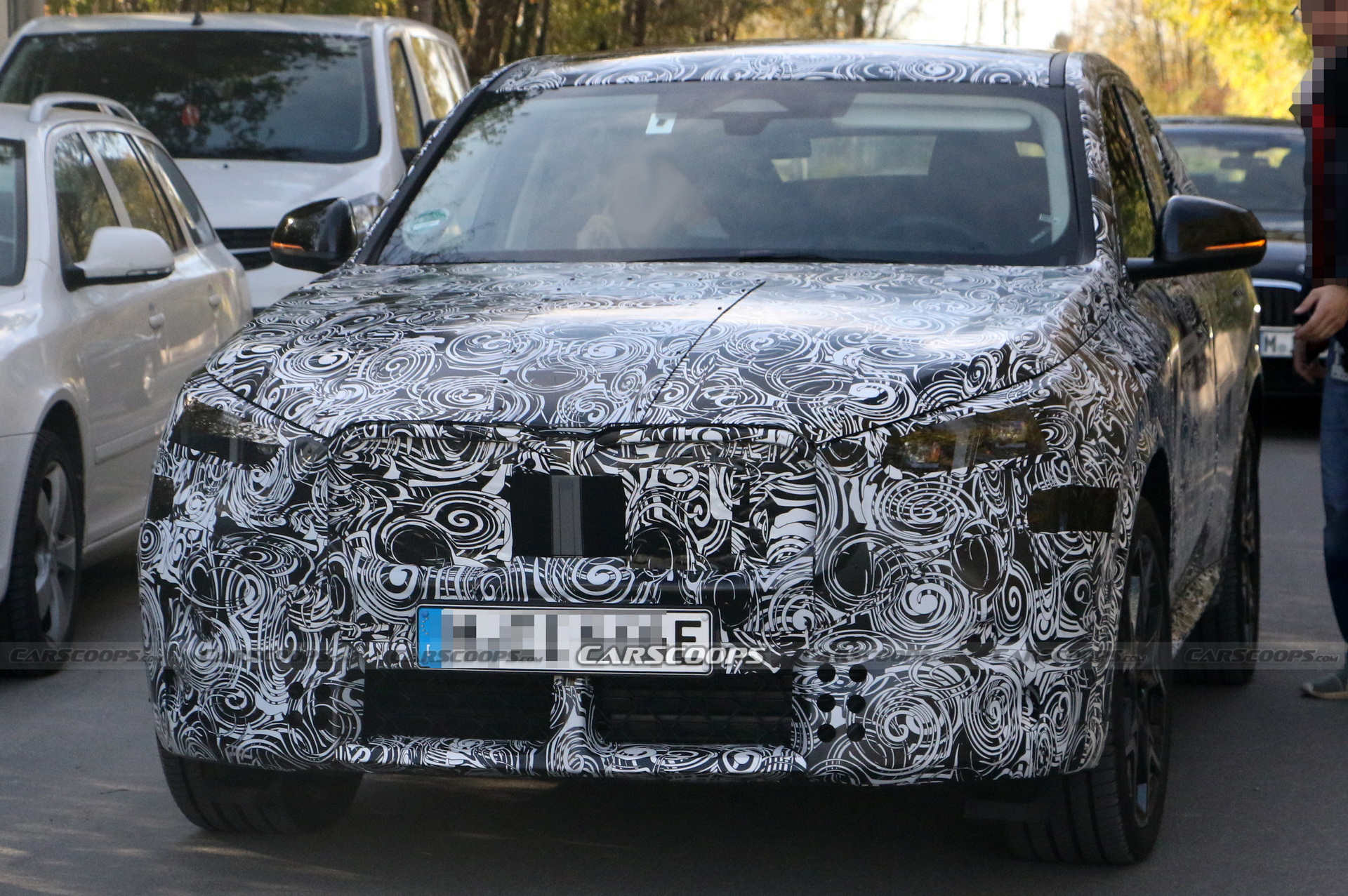 2024 BMW iX2 EV Spied With A Covered Grille And Sloping Roofline