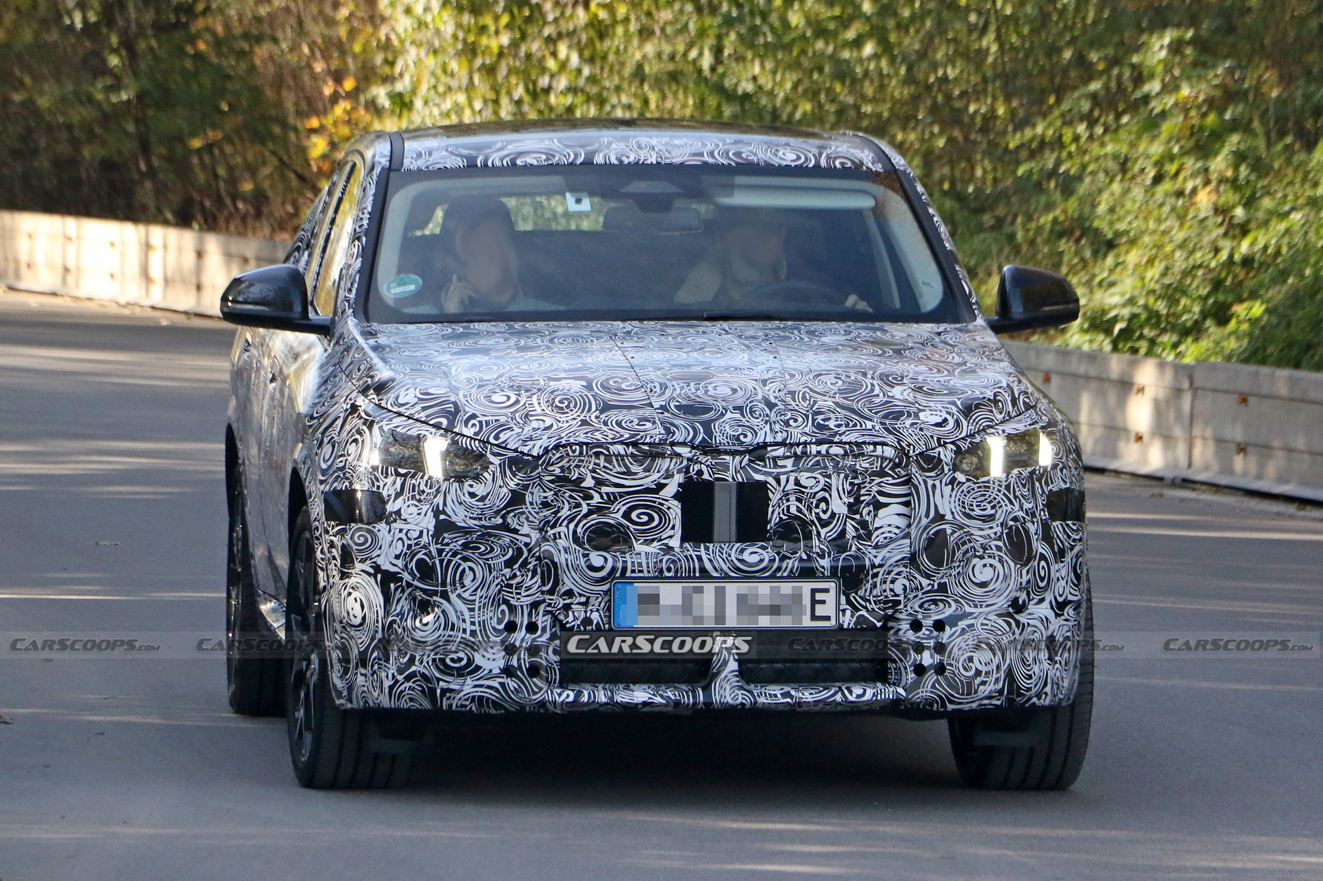 2024 BMW iX2 EV Spied With A Covered Grille And Sloping Roofline