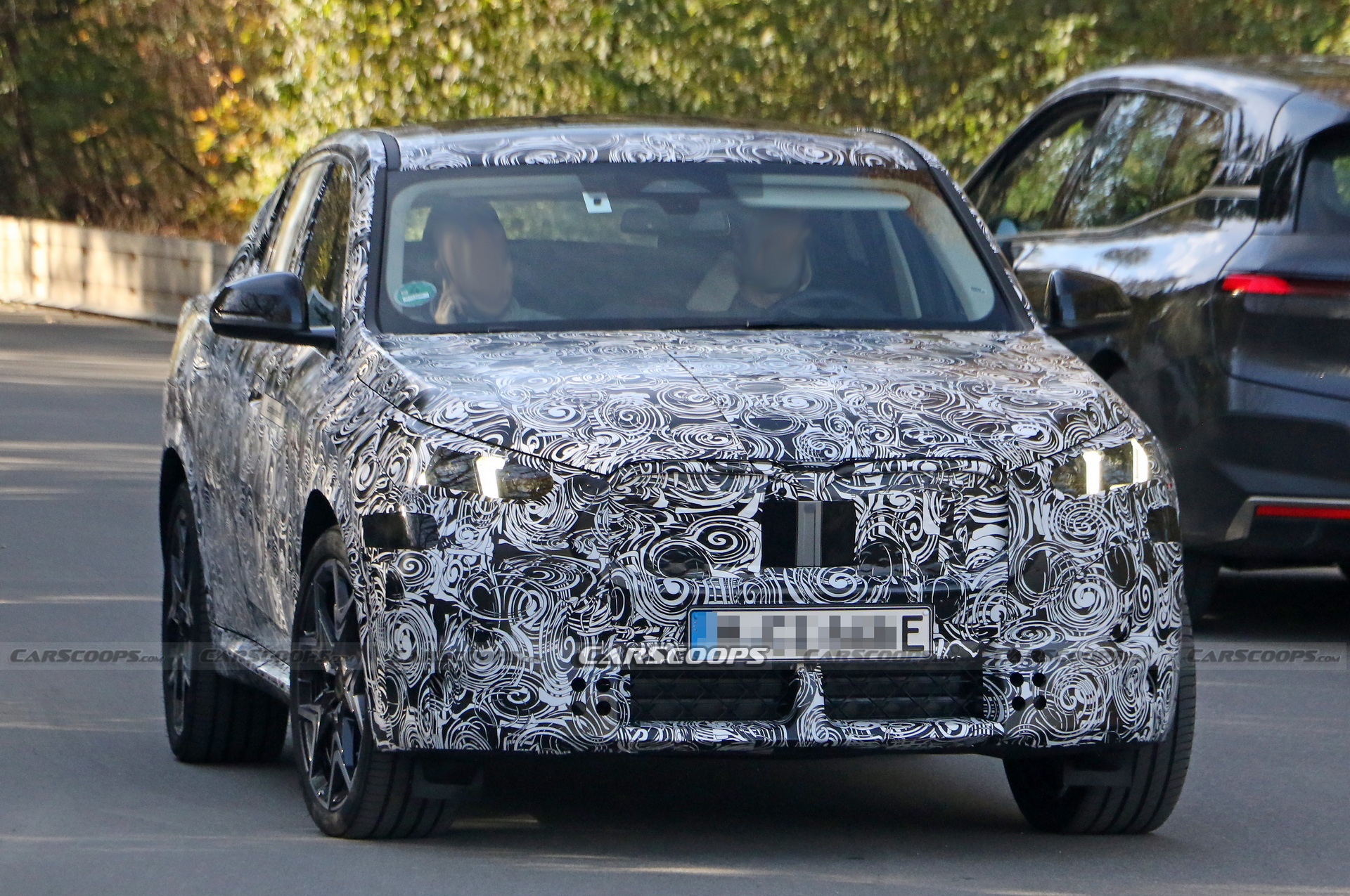 2024 BMW iX2 EV Spied With A Covered Grille And Sloping Roofline