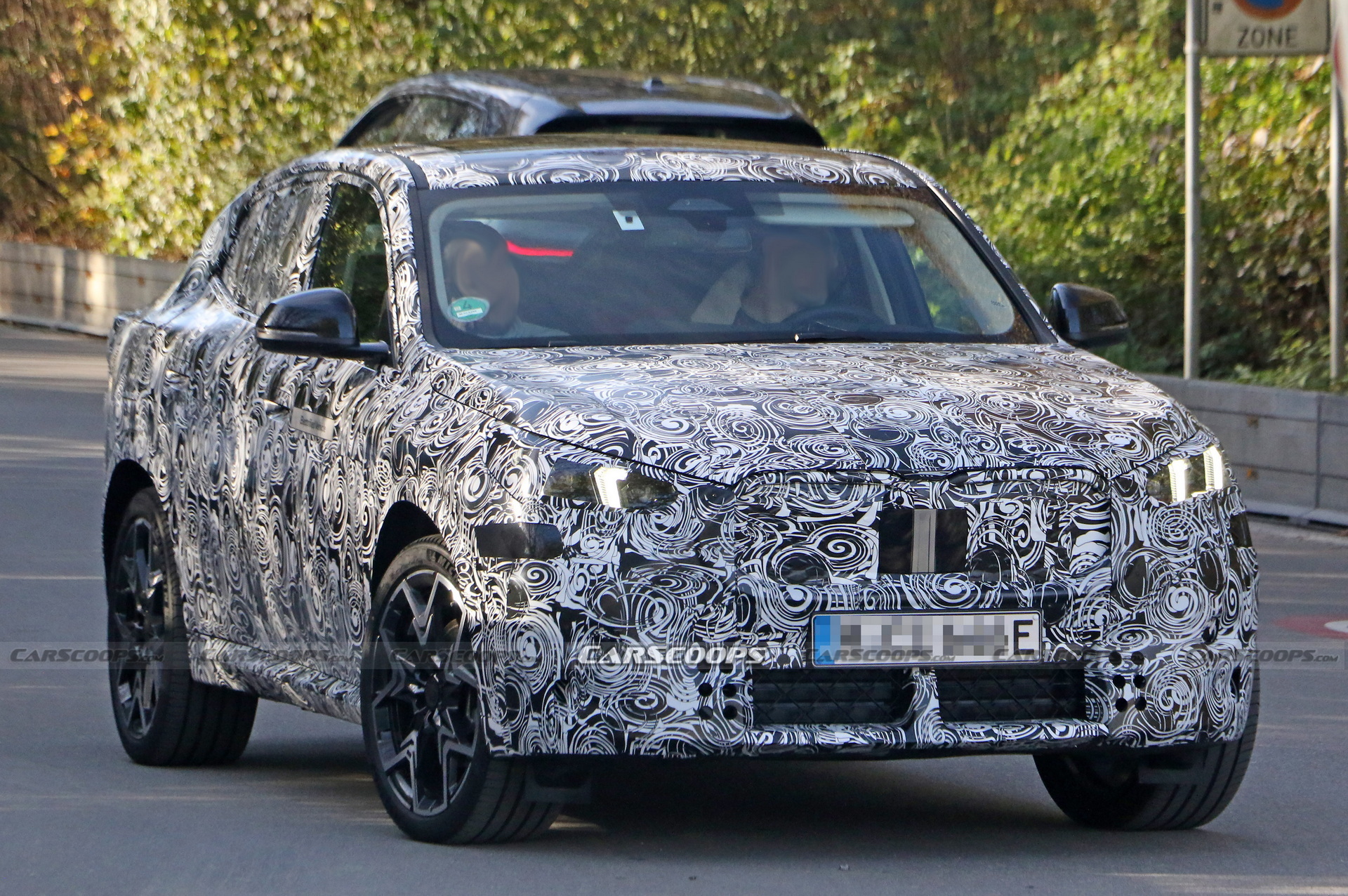2024 BMW iX2 EV Spied With A Covered Grille And Sloping Roofline