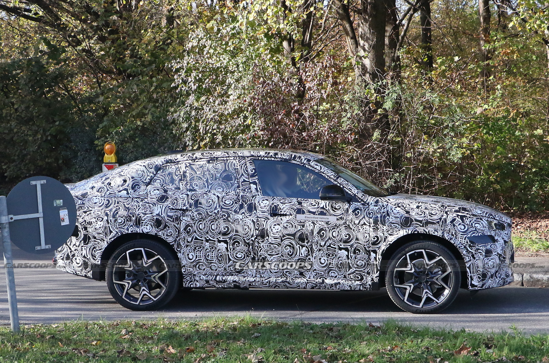 2024 BMW iX2 EV Spied With A Covered Grille And Sloping Roofline