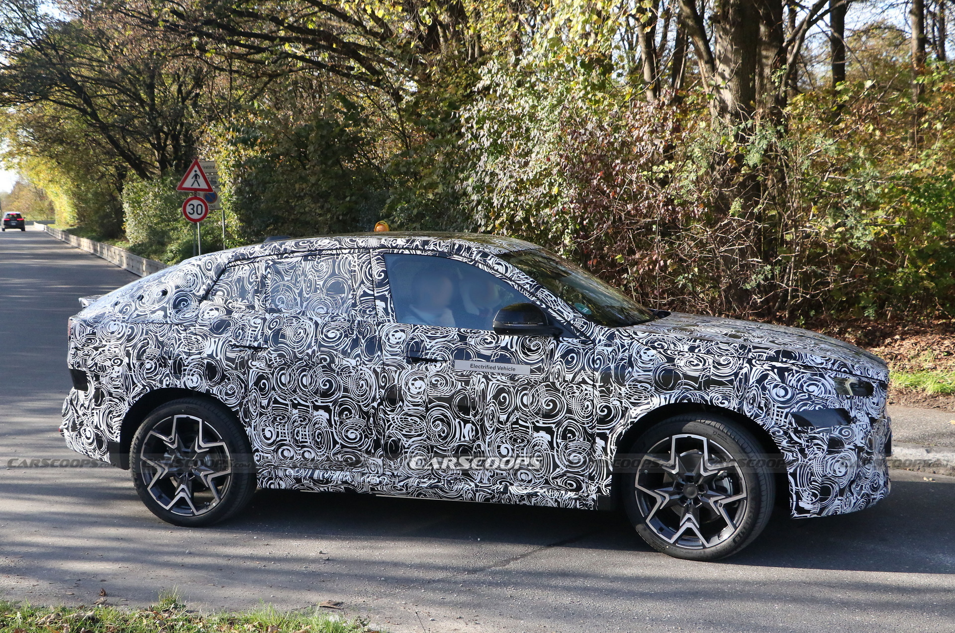 2024 BMW iX2 EV Spied With A Covered Grille And Sloping Roofline