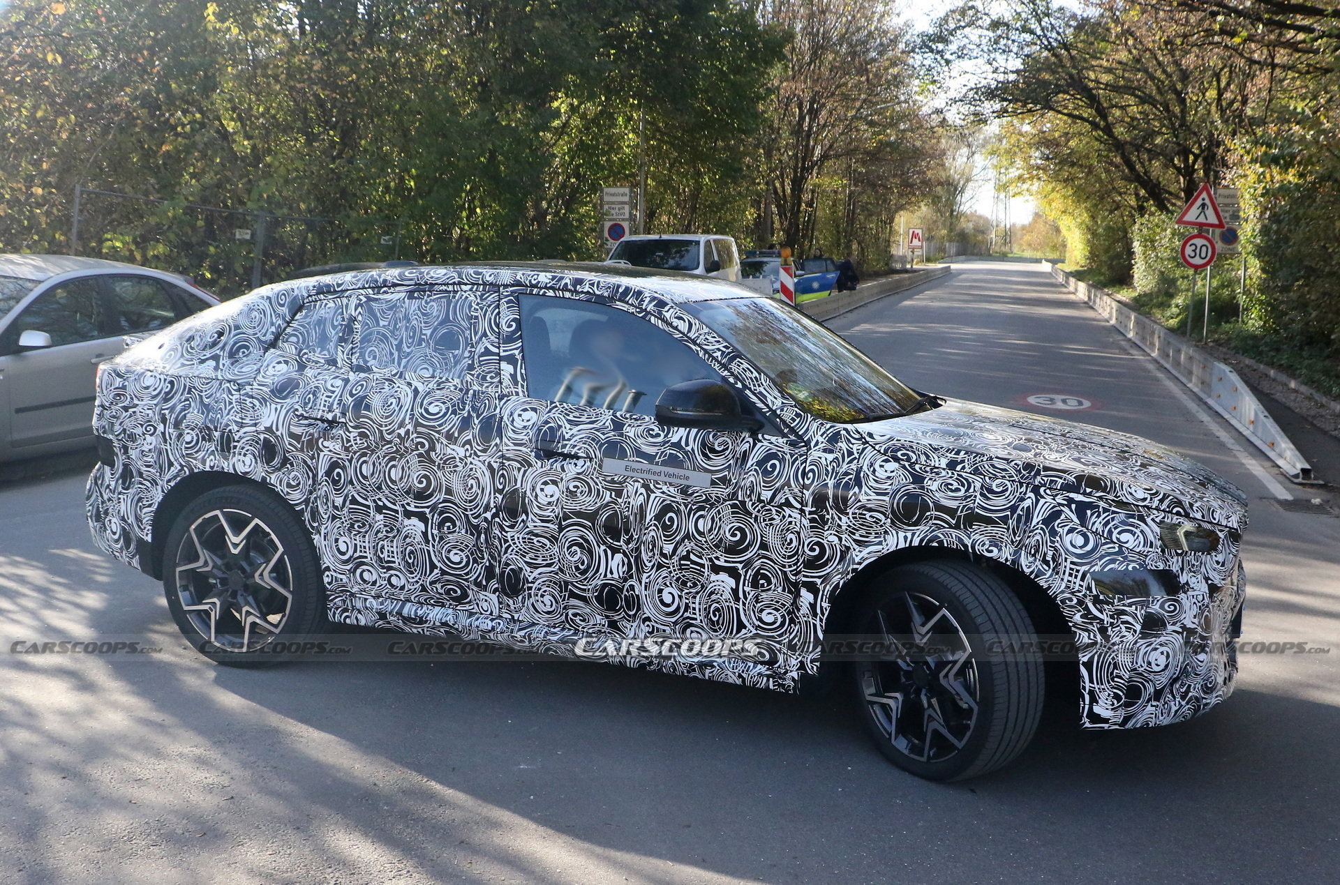 2024 BMW iX2 EV Spied With A Covered Grille And Sloping Roofline