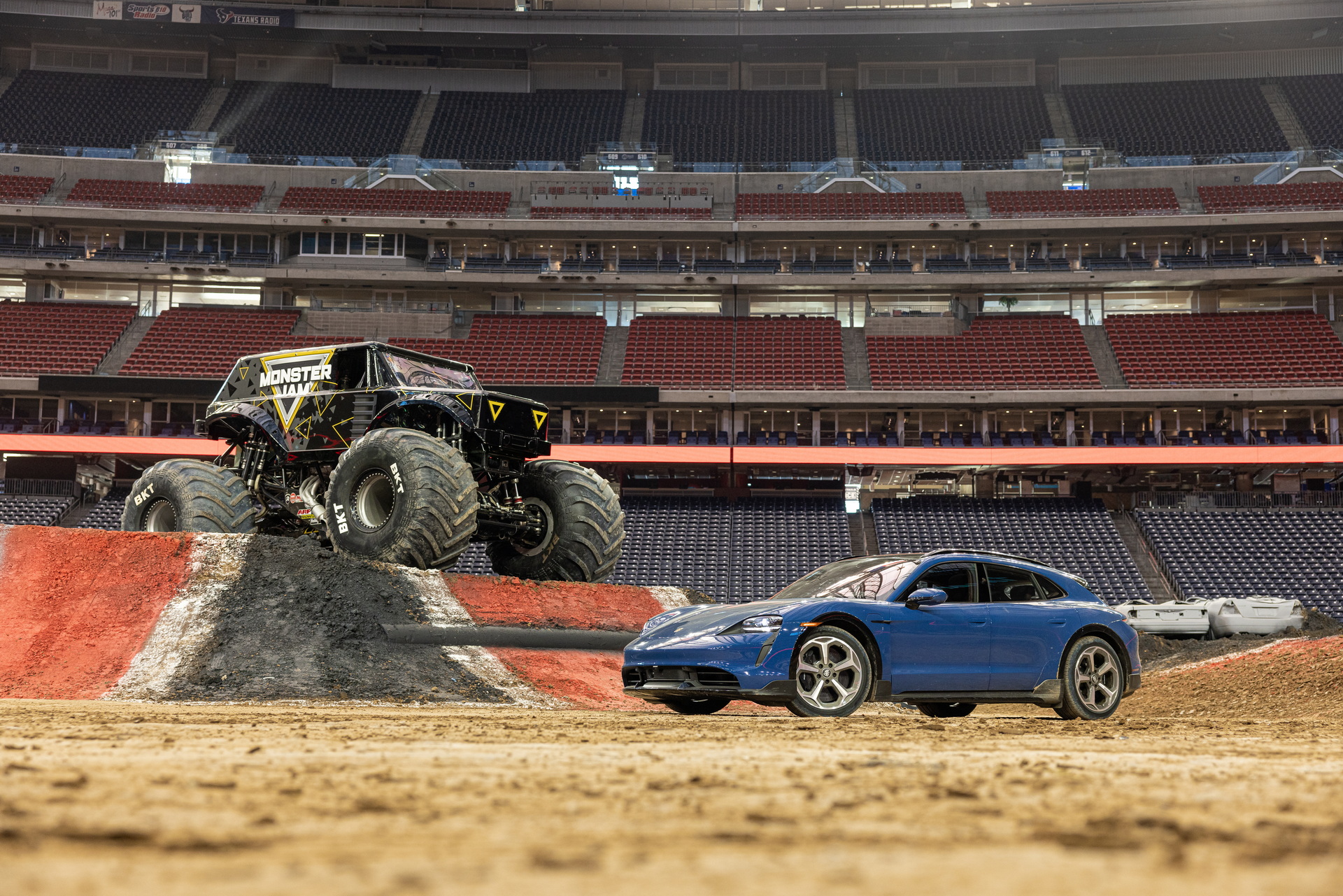 Watch A Monster Truck Flying Over A Porsche Taycan Cross Turismo
