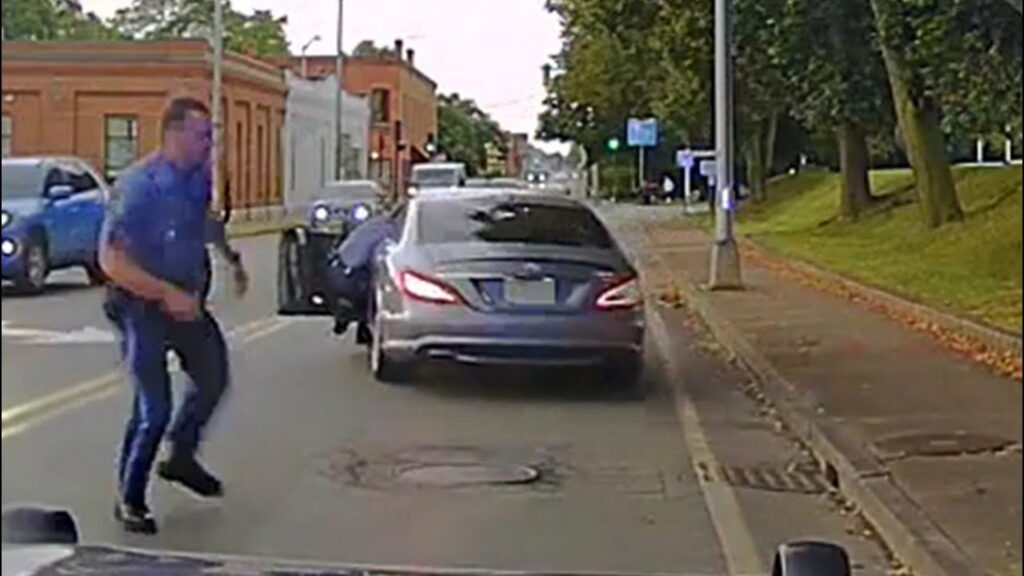  Police Officer Clings To Mercedes CLS As Driver Attempts To Flee From Traffic Stop