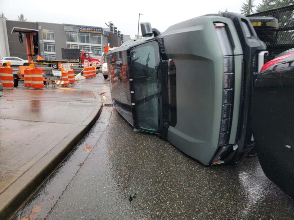  Ouch! Transporter Flips Over Knocking Down GMC Hummer EV And Mercedes