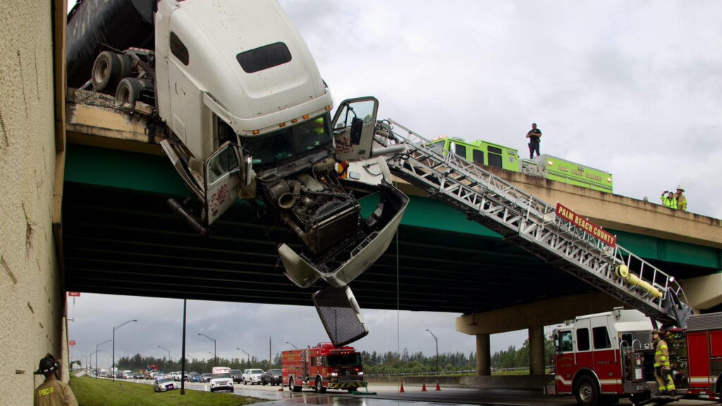  Watch Florida Firefighters Snatch Driver From 18-Wheeler Hanging Off Bridge